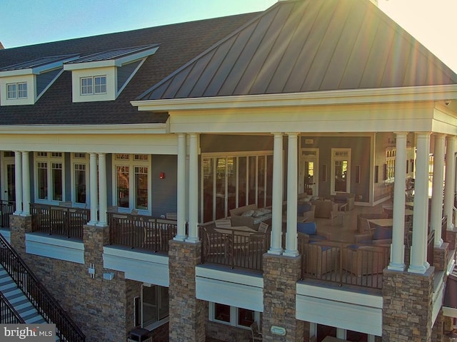 exterior space with metal roof, a standing seam roof, and roof with shingles