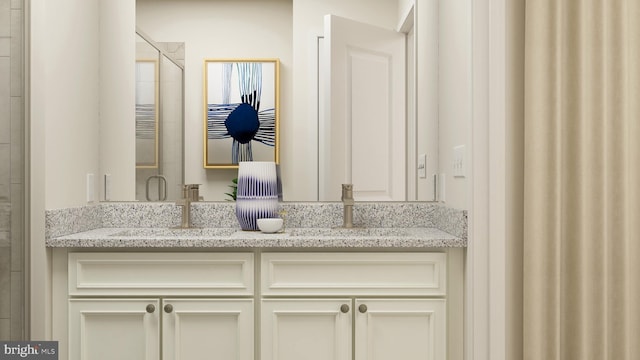 bathroom featuring double vanity, a stall shower, and a sink