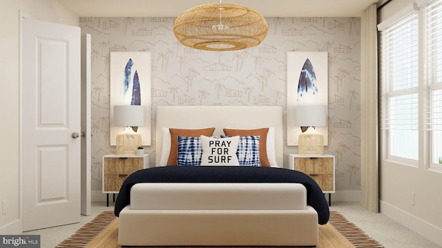 bedroom with wallpapered walls, baseboards, and carpet