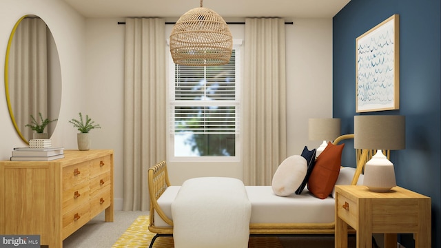 carpeted bedroom with an inviting chandelier
