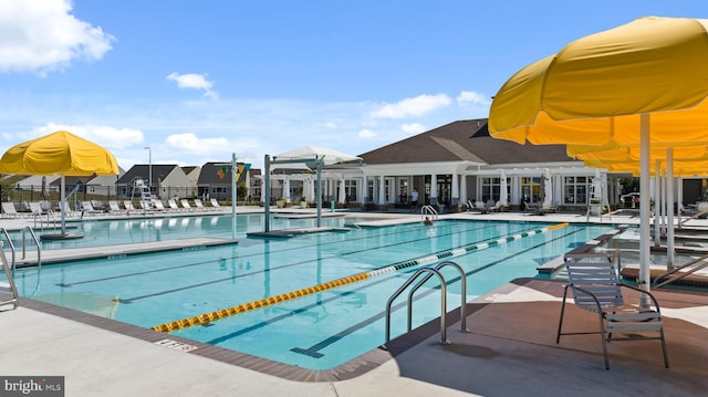 community pool featuring a patio and fence