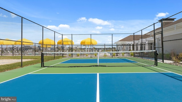view of sport court featuring fence