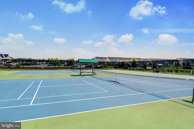 view of tennis court with fence and community basketball court