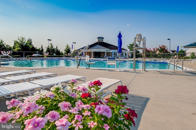 community pool featuring a patio area, fence, and a gazebo