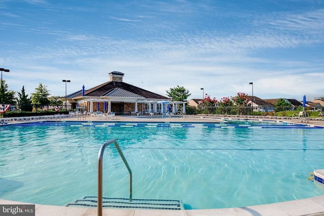 pool featuring fence and a patio