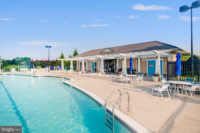 community pool with fence and a patio