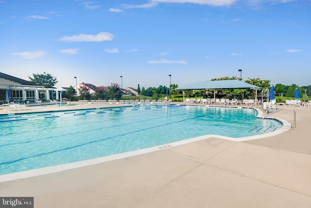 pool featuring a patio area and fence