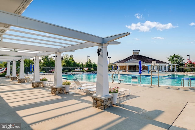 community pool featuring a pergola, fence, and a patio area