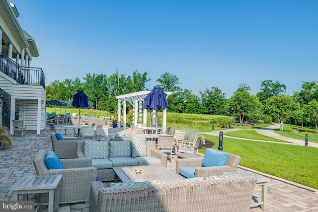view of patio with an outdoor hangout area and a balcony