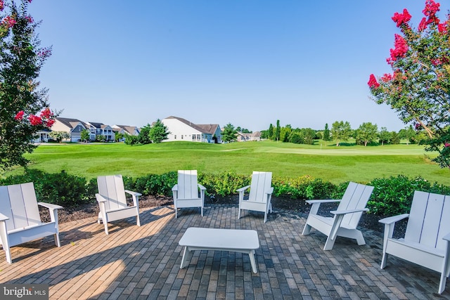 view of patio featuring golf course view and a residential view