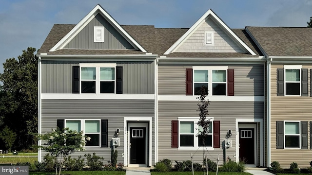 view of front of house with roof with shingles and board and batten siding