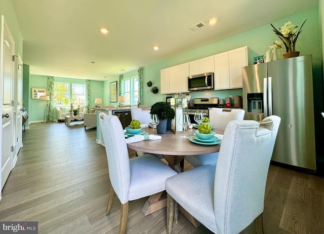 dining space featuring recessed lighting, light wood-style flooring, and visible vents