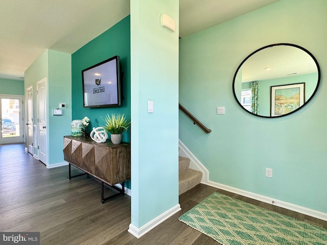 stairway with wood finished floors and baseboards