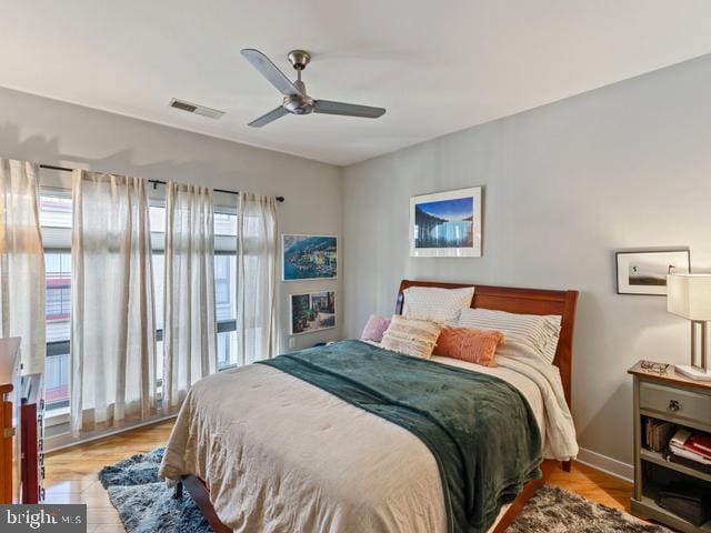 bedroom featuring visible vents, wood finished floors, and ceiling fan