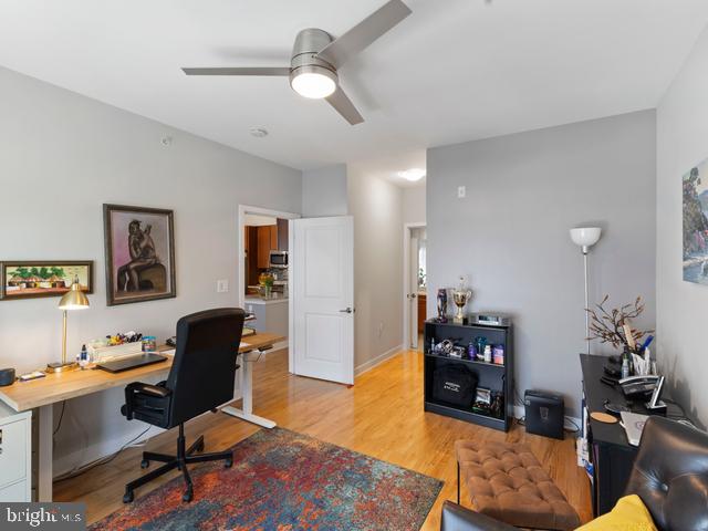 office featuring wood finished floors and a ceiling fan