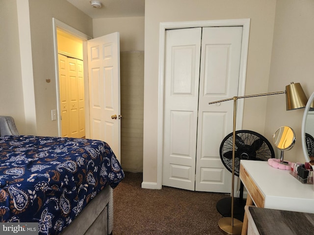 carpeted bedroom with a closet and baseboards