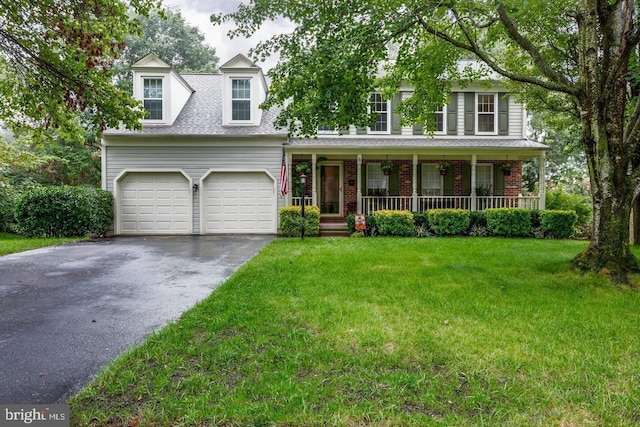 view of front facade featuring driveway, covered porch, a front lawn, a shingled roof, and brick siding