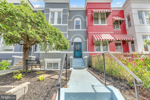 townhome / multi-family property with brick siding and entry steps