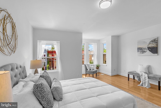 bedroom featuring wood finished floors and baseboards