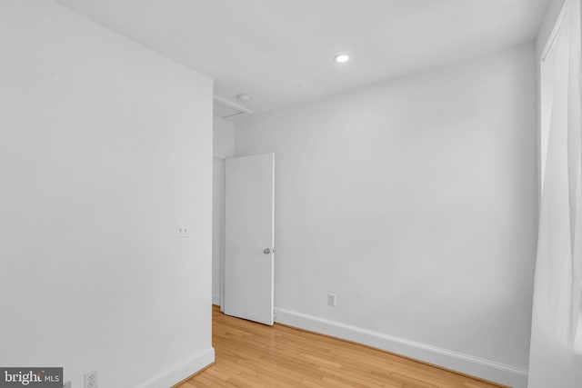 empty room featuring baseboards, light wood-style flooring, and recessed lighting