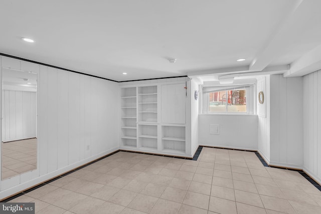 tiled spare room featuring recessed lighting, built in features, and a smoke detector