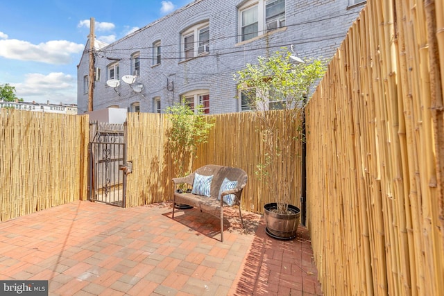 view of patio featuring a gate and fence