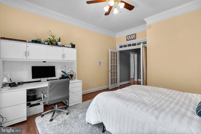 bedroom with crown molding, a desk, dark wood-style floors, ceiling fan, and baseboards