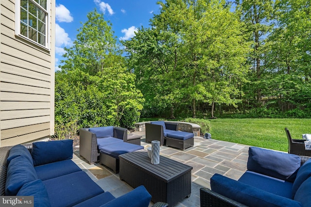 view of patio / terrace with an outdoor hangout area and view of wooded area