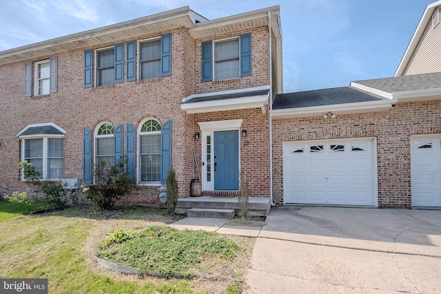 view of front of house with concrete driveway, a garage, and brick siding