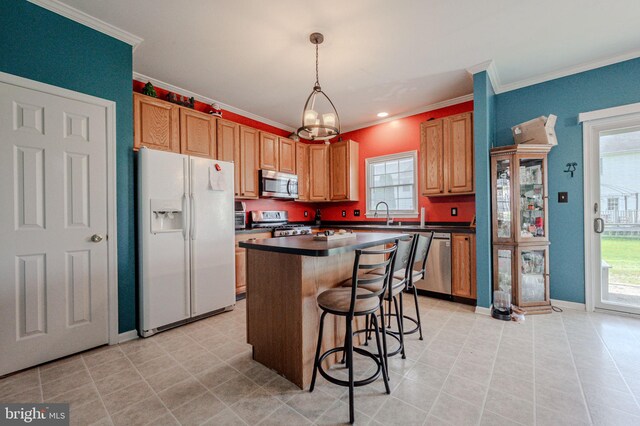 kitchen with ornamental molding, dark countertops, plenty of natural light, and appliances with stainless steel finishes
