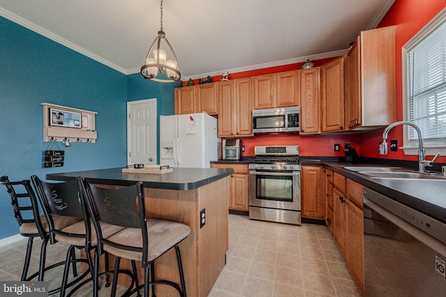 kitchen featuring a sink, ornamental molding, dark countertops, and appliances with stainless steel finishes