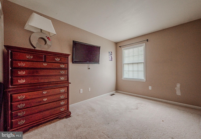 unfurnished bedroom featuring carpet flooring, visible vents, and baseboards