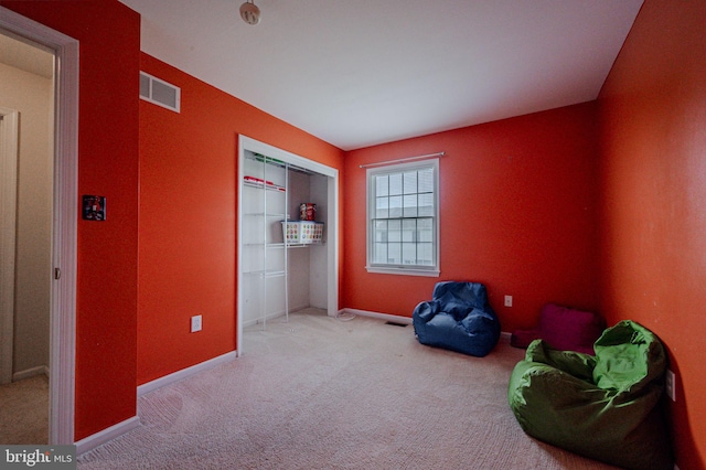 living area featuring baseboards, carpet flooring, and visible vents