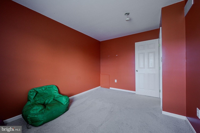 unfurnished room featuring carpet flooring and baseboards