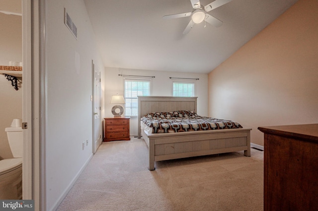 bedroom featuring visible vents, baseboards, ceiling fan, light colored carpet, and lofted ceiling