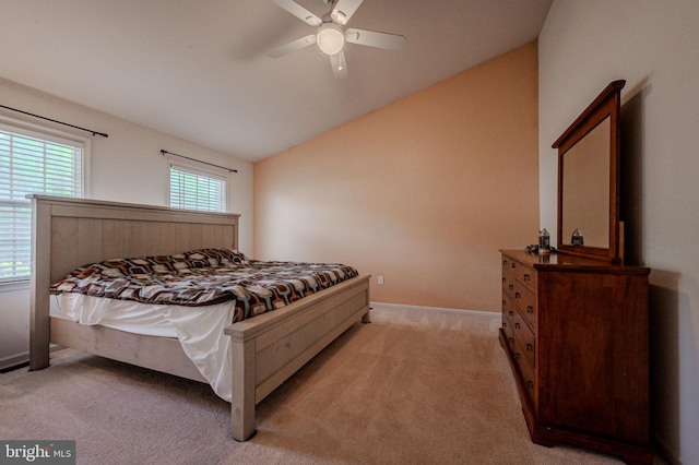 bedroom with lofted ceiling, light carpet, a ceiling fan, and baseboards