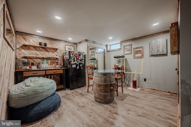 bar with freestanding refrigerator, wood walls, recessed lighting, and wood finished floors