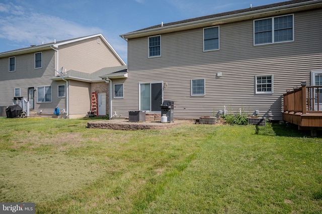 back of house featuring a yard and a wooden deck