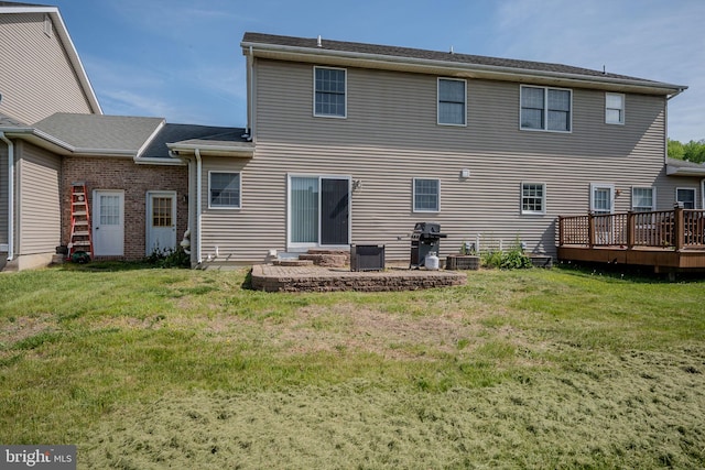 back of house with a lawn, central AC unit, and a wooden deck