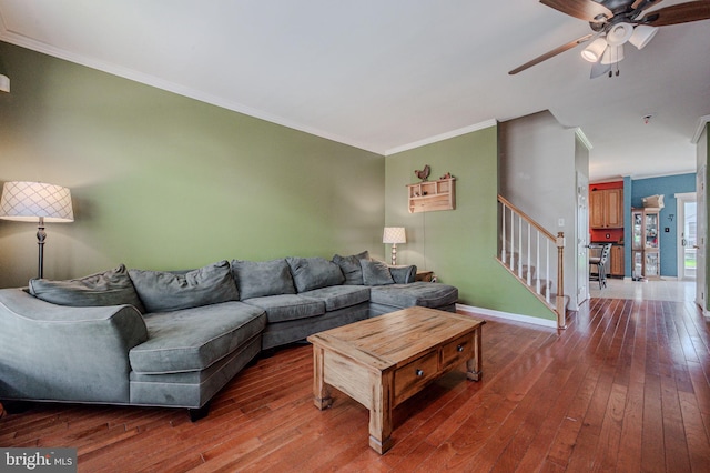 living room with a ceiling fan, stairs, hardwood / wood-style floors, and ornamental molding