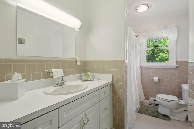 111 Trevanion Rd, Taneytown, MD 21787 - bathroom featuring tile walls, toilet, vanity, and a wainscoted wall