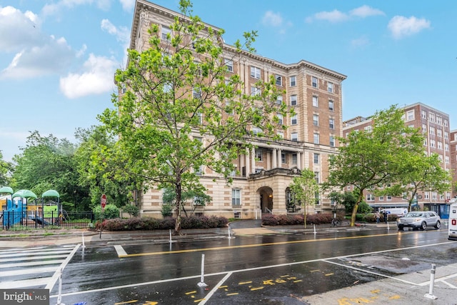 view of apartment building / complex with fence