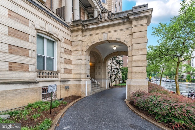 entrance to property featuring brick siding