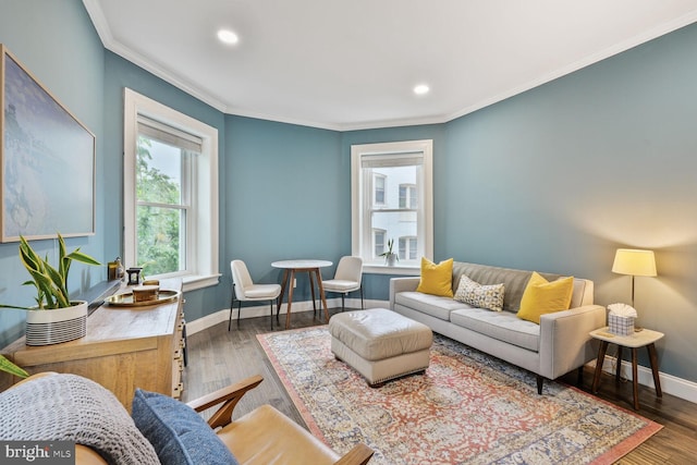living area with baseboards, crown molding, recessed lighting, and wood finished floors
