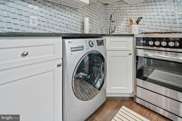 laundry area with washer / clothes dryer and dark wood finished floors