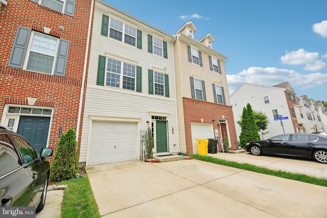 multi unit property featuring driveway, a garage, and brick siding