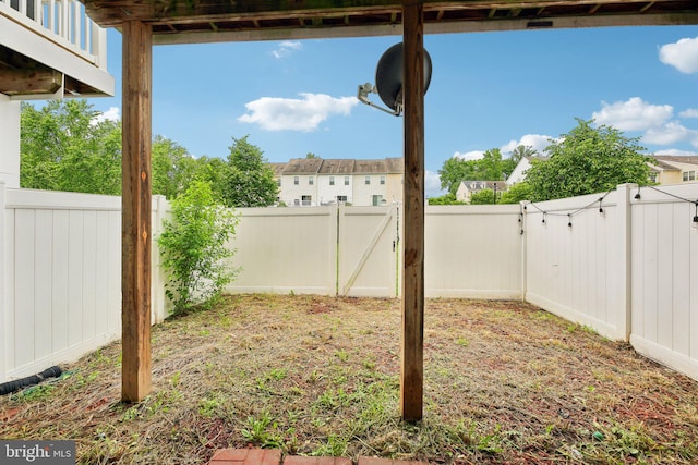 fenced backyard with a gate