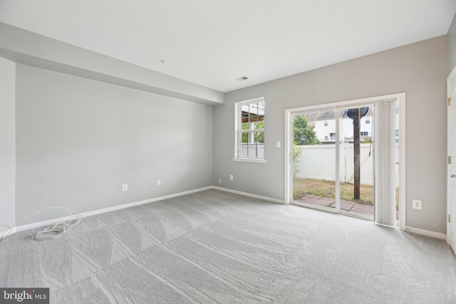 unfurnished room with carpet and baseboards