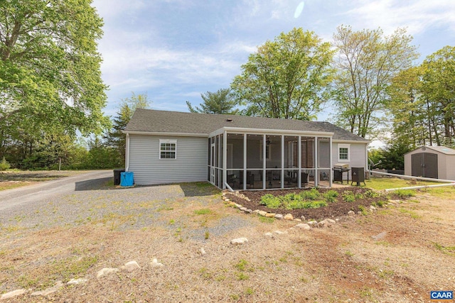 654 Bybee Rd, Louisa, VA 23093 - back of house featuring a storage unit, a sunroom, and an outdoor structure