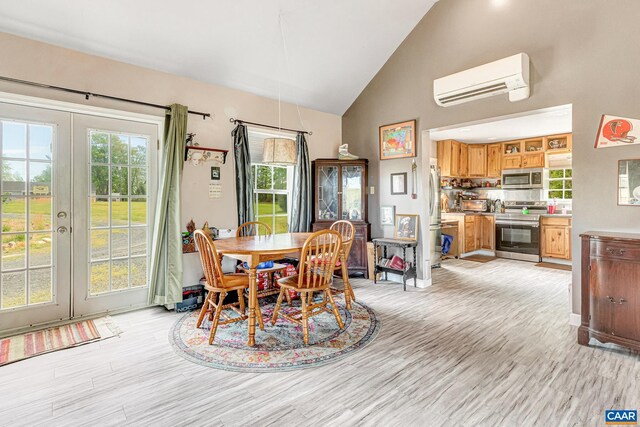 654 Bybee Rd, Louisa, VA 23093 - dining room featuring a wall mounted AC, french doors, high vaulted ceiling, and light wood-style flooring